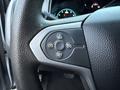 Close-up of a steering wheel control panel with buttons for cruise control adjustment and settings in a 2018 Chevrolet Colorado