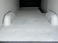 Interior floor of a 2012 Mercedes-Benz Sprinter van showing a flat surface with two wheel wells on either side
