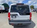 A silver 2006 Land Rover LR3 with a blacked-out rear window and a distinctive tailgate design