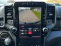 A 2019 RAM 1500 dashboard display showing a rearview camera with guiding lines and controls for heated seats and steering wheel