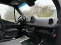 Interior of a 2023 Mercedes-Benz Sprinter showcasing the dashboard and front seats with a modern design and user interface