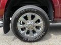 Close-up of a chrome wheel with a Firestone tire mounted on a 2024 RAM 3500 showing detailed spoke design and tire tread pattern