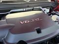 Close-up of a 2018 GMC Canyon engine cover featuring a V6 Direct Injection logo in a reddish hue