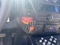 A 2020 Chevrolet Express dashboard featuring a keychain with keys and a red sticker that reads "ENSURE DOORS UNLOCKED AND OPERATED"