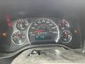 The dashboard of a 2014 GMC Savana showing speedometer fuel gauge and warning lights
