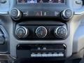 Dashboard controls of a 2022 RAM 5500 featuring temperature and audio controls along with various buttons for vehicle settings and towing features
