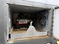 A battery compartment inside a 2020 Chevrolet Express with a Canada Proof battery and connected cables