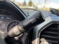 A close-up of the gear shift lever on a 2021 Ford F-550 with a label indicating "DRIVE MODE" on the side