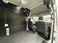 Interior of a 2020 Ford Transit with two front seats visible and a spacious cargo area designed for transporting goods