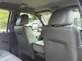 Interior view of a 2011 Ford F-350 SD showing two front seats and a center console with a gray leather finish