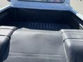 The image shows the bed of a 1962 Ford F-100 truck with textured black lining and a raised indent in the center