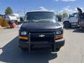 A 2012 Chevrolet Express van with a black exterior and a front grille guard