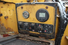 Control panel of a 2015 Vermeer Corporation BC1200XL featuring various gauges switches and buttons