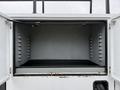 The image shows the open storage compartment of a 2020 Ford F-550 with empty shelving and a black floor