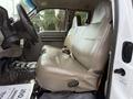 The interior of a 2008 Ford F-450 SD features a beige bench seat with armrests and seat belts on either side