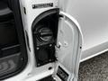 A close-up of the fuel filler door of a 2023 Mercedes-Benz Metris showing the cap and fuel type information