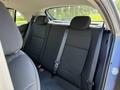 Interior view of the back seat of a 2018 Kia Rio5 featuring two headrests three seat belts and fabric upholstery in black