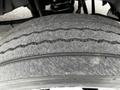 Close-up of a worn tire tread on a 2011 Ford F-550 showing visible grooves and signs of wear on the rubber surface