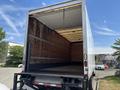 A 2015 Freightliner M2 106 truck with an empty cargo area and a closed rear door