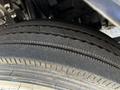 Close-up of a tire from a 2016 Isuzu NPR showing textured tread patterns and sidewall detail