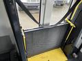 A yellow and gray metal ramp with a mesh surface is positioned at the entrance of a 2018 Chevrolet Express vehicle