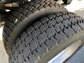 Close-up of a pair of worn tires from a 2018 Ford F-550 with deep tread patterns and visible wear indicating usage