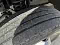 Close-up of a worn tire on a 2008 Ford F-550 showing visible tread wear and dirt on the surface