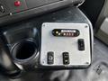 Control panel with buttons and indicators labeled including a door ajar signal and various switches for vehicle functions