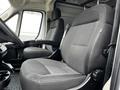 Interior view of a 2021 RAM Promaster showcasing the driver's and passenger's seats with a grey fabric pattern and armrests