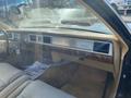 Interior of a 1982 Mercury Grand Marquis featuring a beige dashboard wood accents and a classic radio display