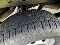 Close-up of a rugged tire showcasing deep treads designed for traction on various surfaces