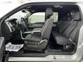 A 2014 Ford F-150 interior showcasing the front seats with a large center console and clean dashboard design