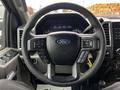 Steering wheel of a 2017 Ford F-550 with controls and the Ford logo prominently displayed in the center