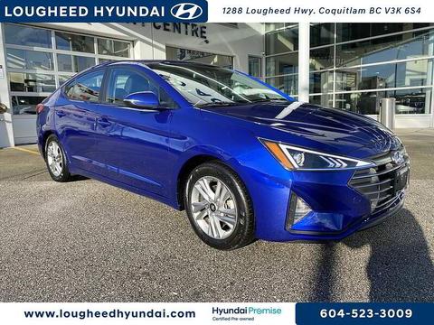 A blue 2020 Hyundai Elantra parked at a dealership featuring a sleek design with modern headlights and alloy wheels