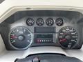 The dashboard of a 2008 Ford F-550 featuring a speedometer tachometer fuel gauge and digital displays for hours and odometer with gear shift indicator