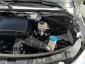 The engine compartment of a 2017 Mercedes-Benz Sprinter showing the air intake system and fluid reservoir with a blue cap