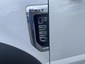 Close-up of a metallic emblem on a 2017 Ford F-550 showing the model number F-550 and the trim designation XLT