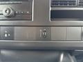 Dashboard controls of a 2014 GMC Savana including buttons for audio settings and auxiliary input