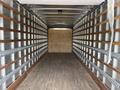 Interior view of a 2022 International MV607 empty cargo truck with wooden slats along the walls and a wooden floor