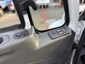 Interior view of a 2013 International Durastar 4300 showing control buttons for mirrors and window adjustments on the driver's side door