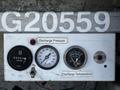 A white control panel featuring three gauges labeled Discharge Pressure Discharge Temperature and a hour meter with readings and dials visible