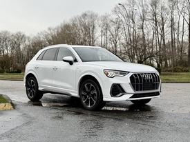 A 2024 Audi Q3 in white with a sleek design features a large front grille and sporty black wheels