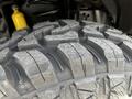 Close-up of a rugged tire tread of a 2017 Ford F-250 SD showcasing deep grooves and a textured surface designed for off-road traction