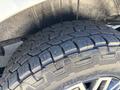 Close-up of a rugged tire with deep treads mounted on a 2019 Mercedes-Benz Sprinter vehicle