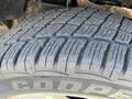 Close-up of a Cooper tire on a 2014 Ford F-150 showcasing the tread pattern and texture of the rubber surface