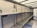 A 2012 Ford Econoline with metal shelves installed in the cargo area designed for storage and organization
