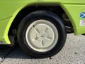 Close-up of a tire on a 2015 Tennant 636 Green Machine featuring a white rim with five holes and a black tire with grooves