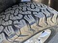 Close-up of a tire from a 2015 RAM 1500 showcasing its rugged tread pattern and metallic wheel rim