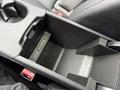 Close-up of a center console storage compartment in a 2016 Mercedes-Benz GLA-250 featuring USB ports for charging devices