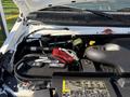 Close-up view of the engine compartment of a 2015 Ford Econoline featuring the battery and various engine components